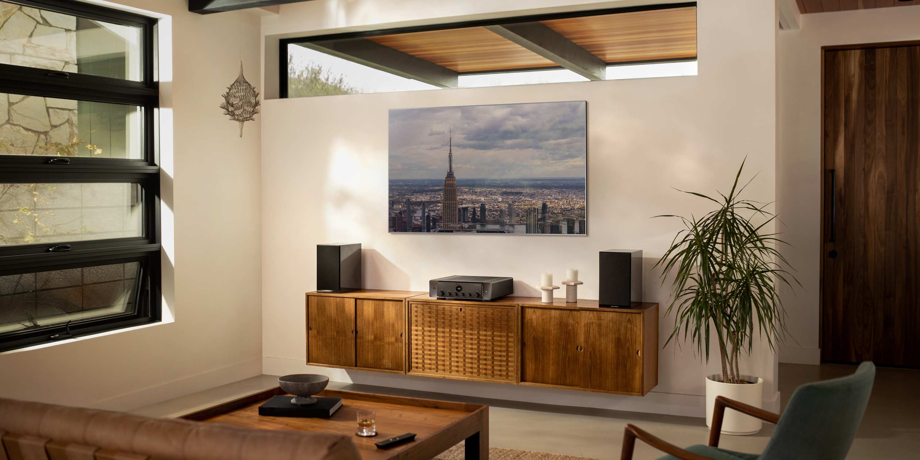 Media Room with marantz technology on a wooden console and a plant